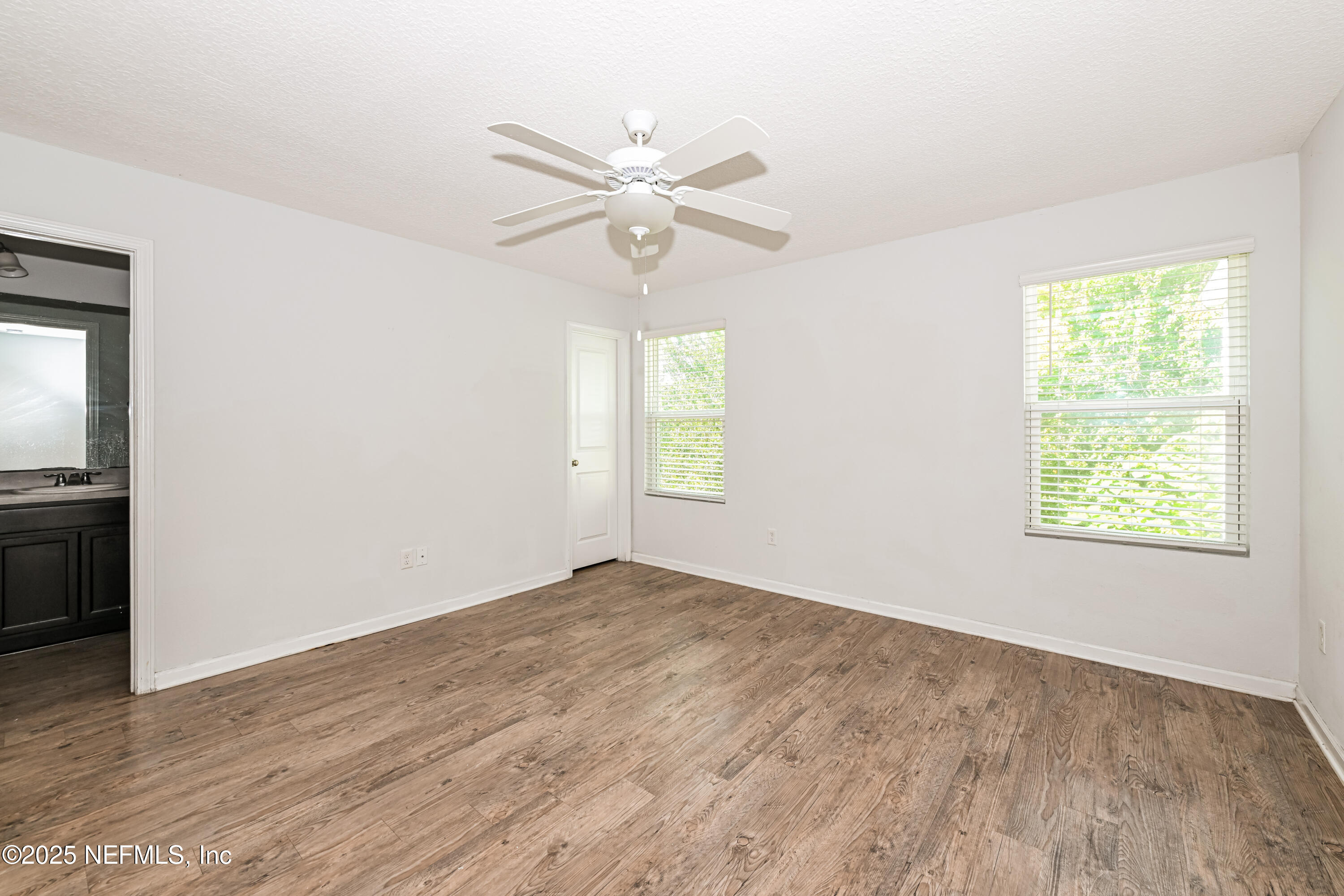 548 Eiseman Way Jacksonville, FL 32216 - Photo 8 of 15 a view of empty room with wooden floor and fan
