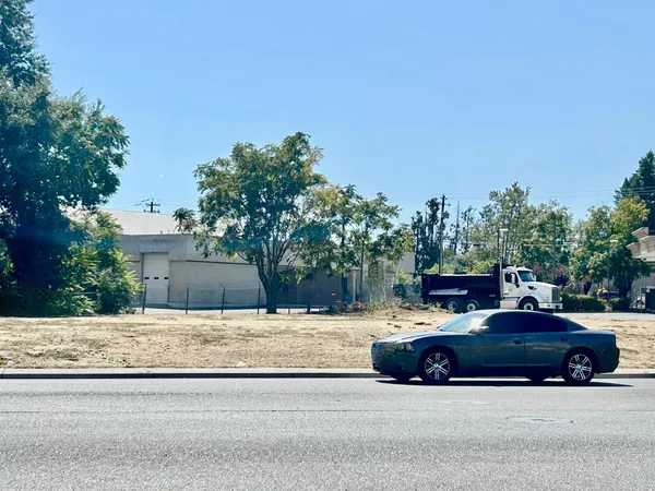 a view of street with parked cars