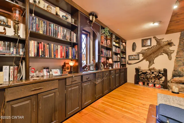a living room with furniture fireplace and a large window