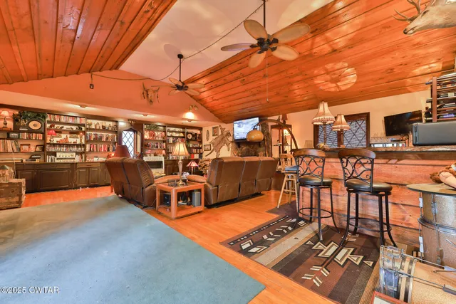 a living room with furniture and a floor to ceiling window