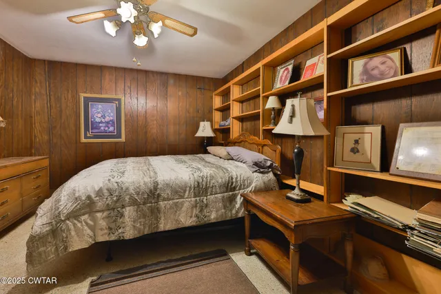 a living room with furniture a piano and a flat screen tv