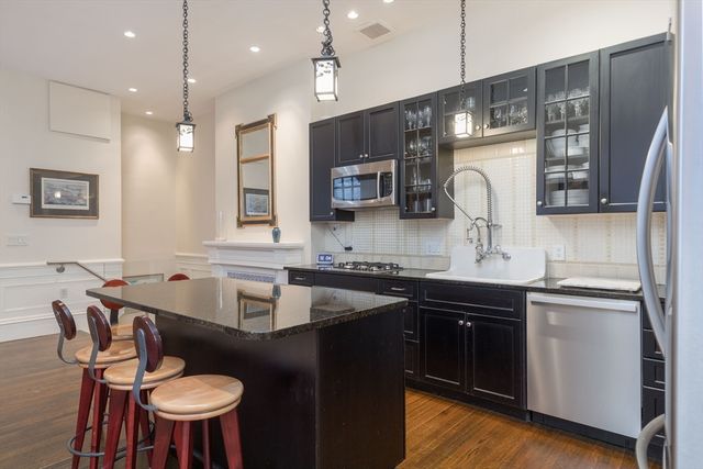 a kitchen with a sink stove and microwave