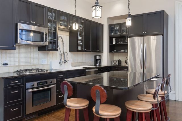 a kitchen with a sink stove and refrigerator