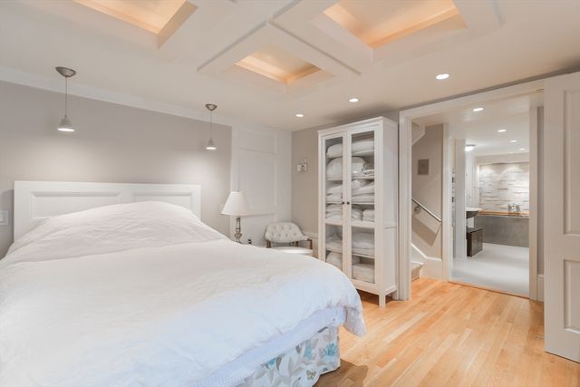 a spacious bedroom with a large bed and a wooden floor