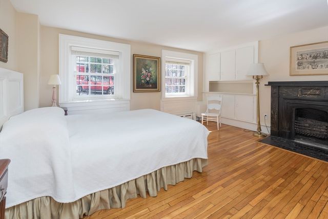 a spacious bedroom with a bed and a fireplace