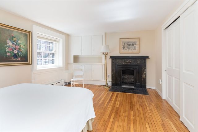 a bedroom with a bed and a fireplace