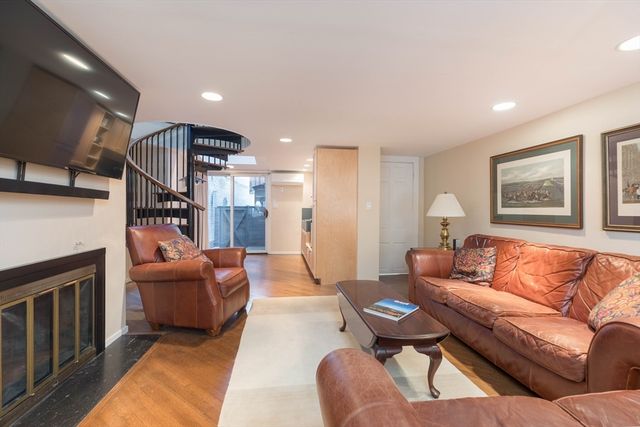 a living room with furniture fireplace and a window