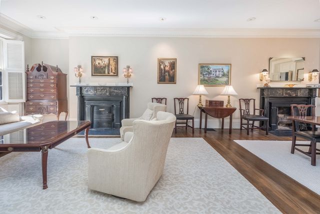a living room with furniture a fireplace and a table