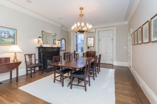 a view of a dining room with furniture a chandelier and wooden floor