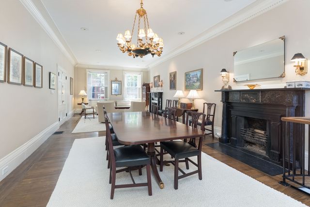 a dining room with furniture a fireplace and chandelier