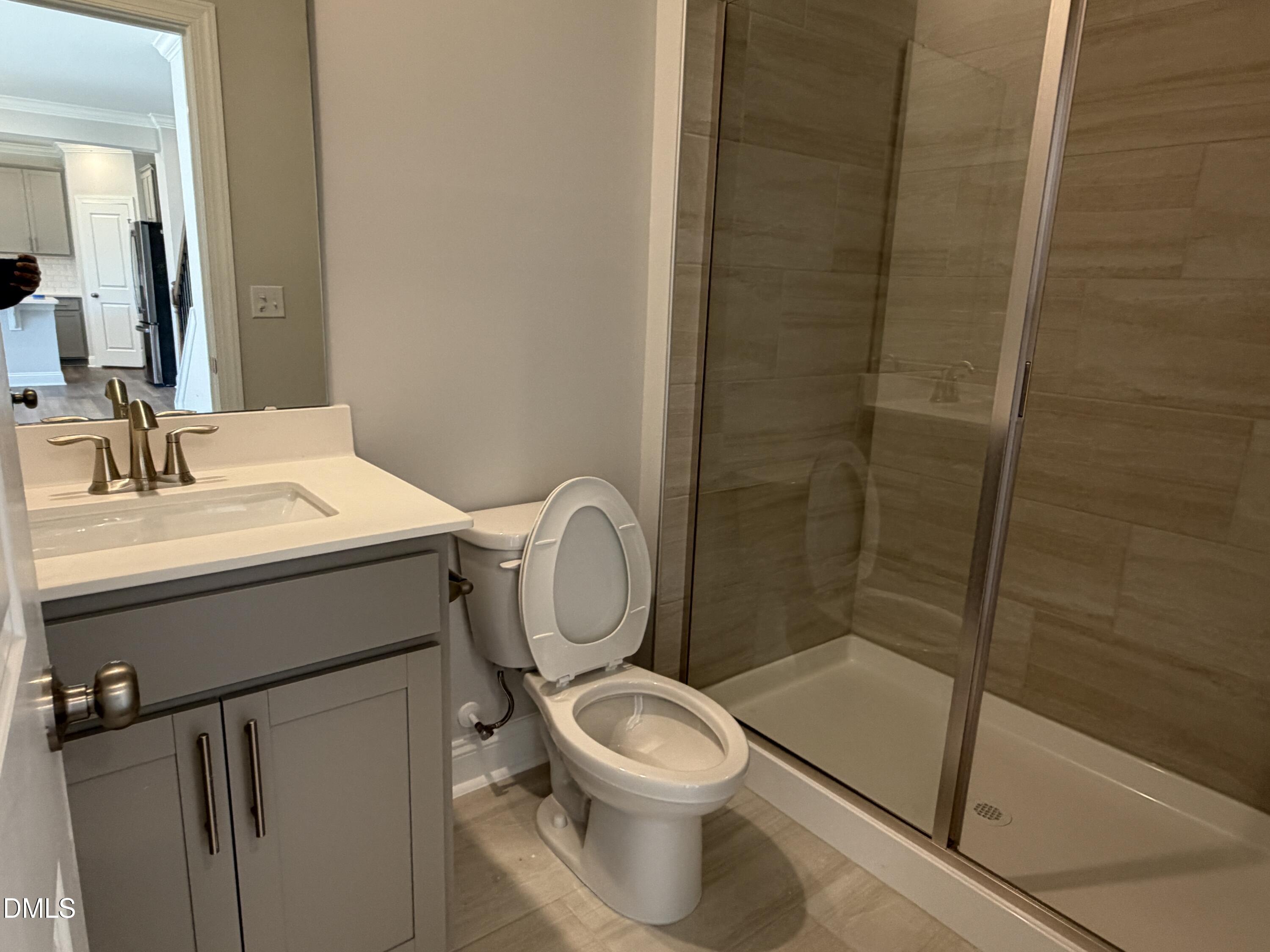 3016 Sandy Bluff Road Raleigh, NC 27616 - Photo 13 of 34 a bathroom with a toilet sink vanity and shower