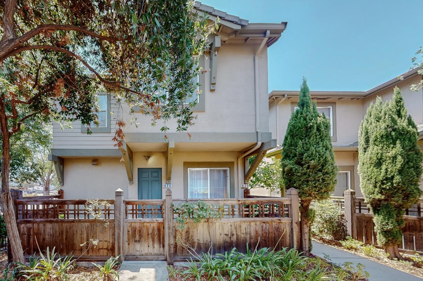 front view of a house with potted plants