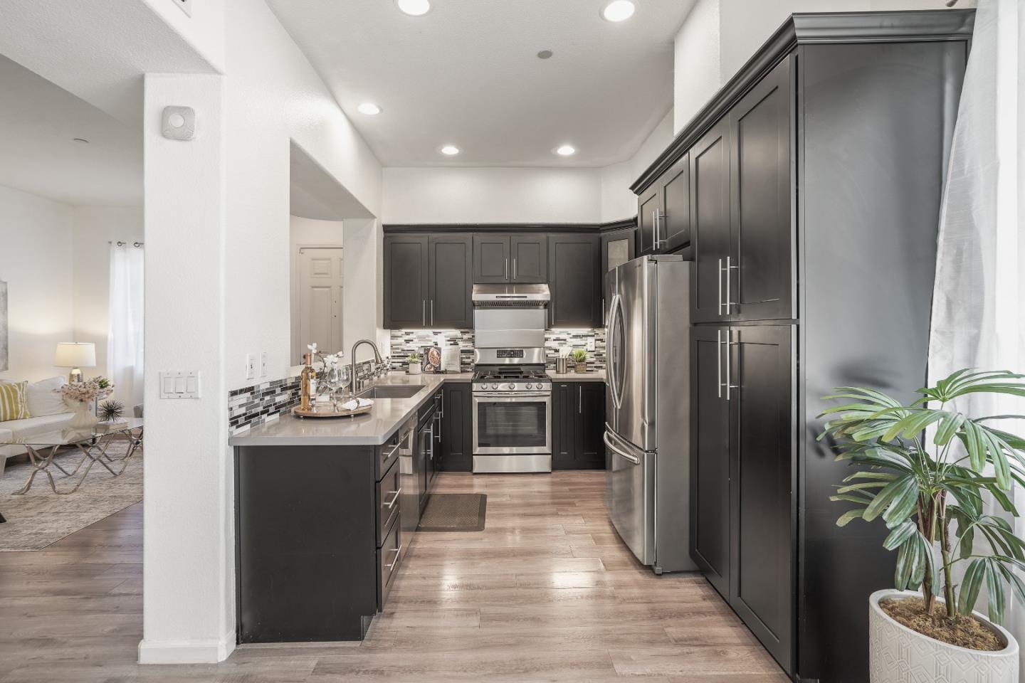 894 Fascination Place Milpitas, CA 95035 - Photo 10 of 30 a kitchen with kitchen island stainless steel appliances a sink stove and refrigerator