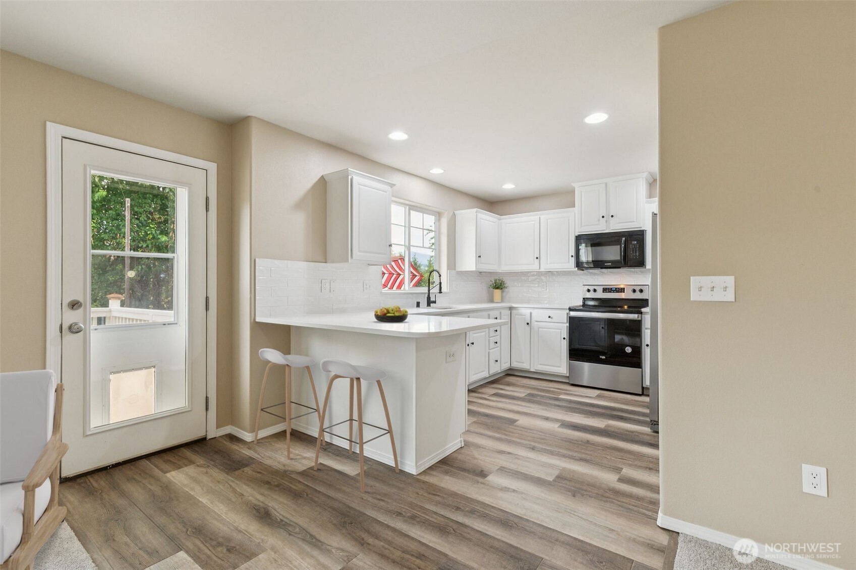 323 Helen Street Sedro-Woolley, WA 98284 - Photo 13 of 34 a kitchen with white cabinets and white appliances