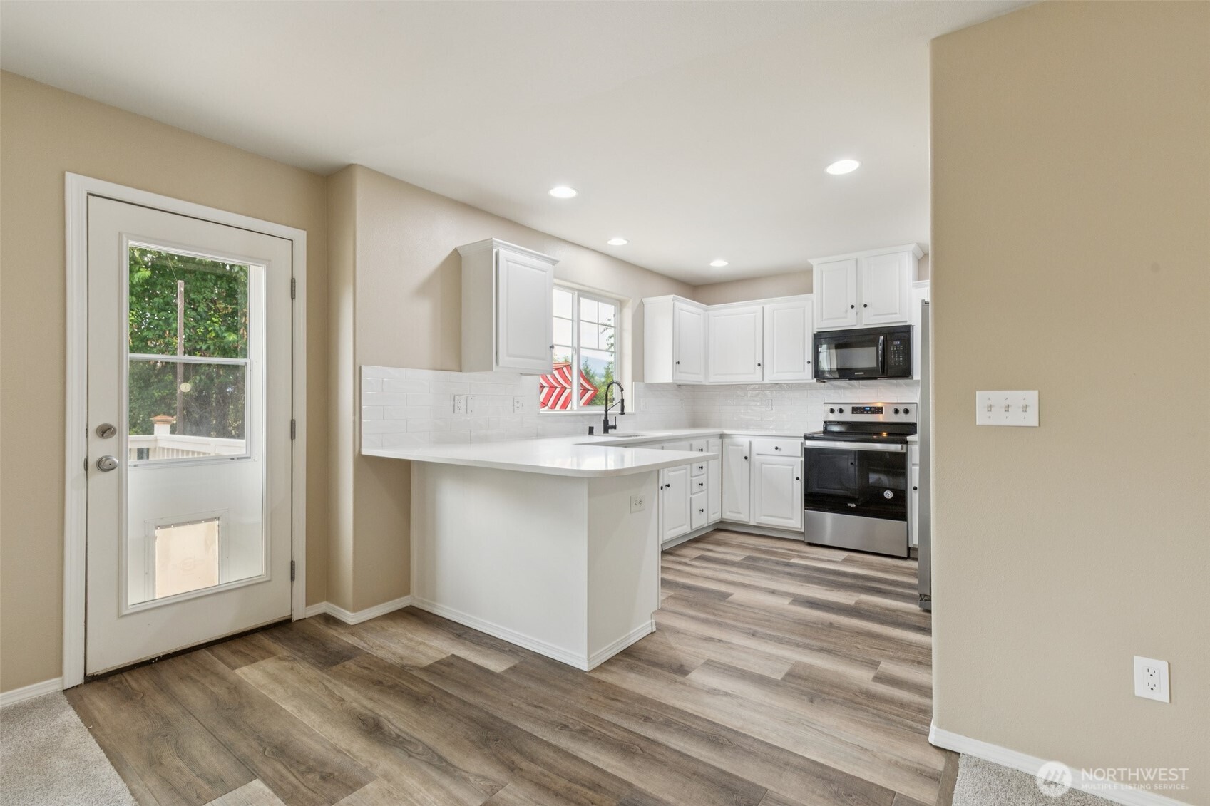 323 Helen Street Sedro-Woolley, WA 98284 - Photo 14 of 34 a kitchen with white cabinets and window