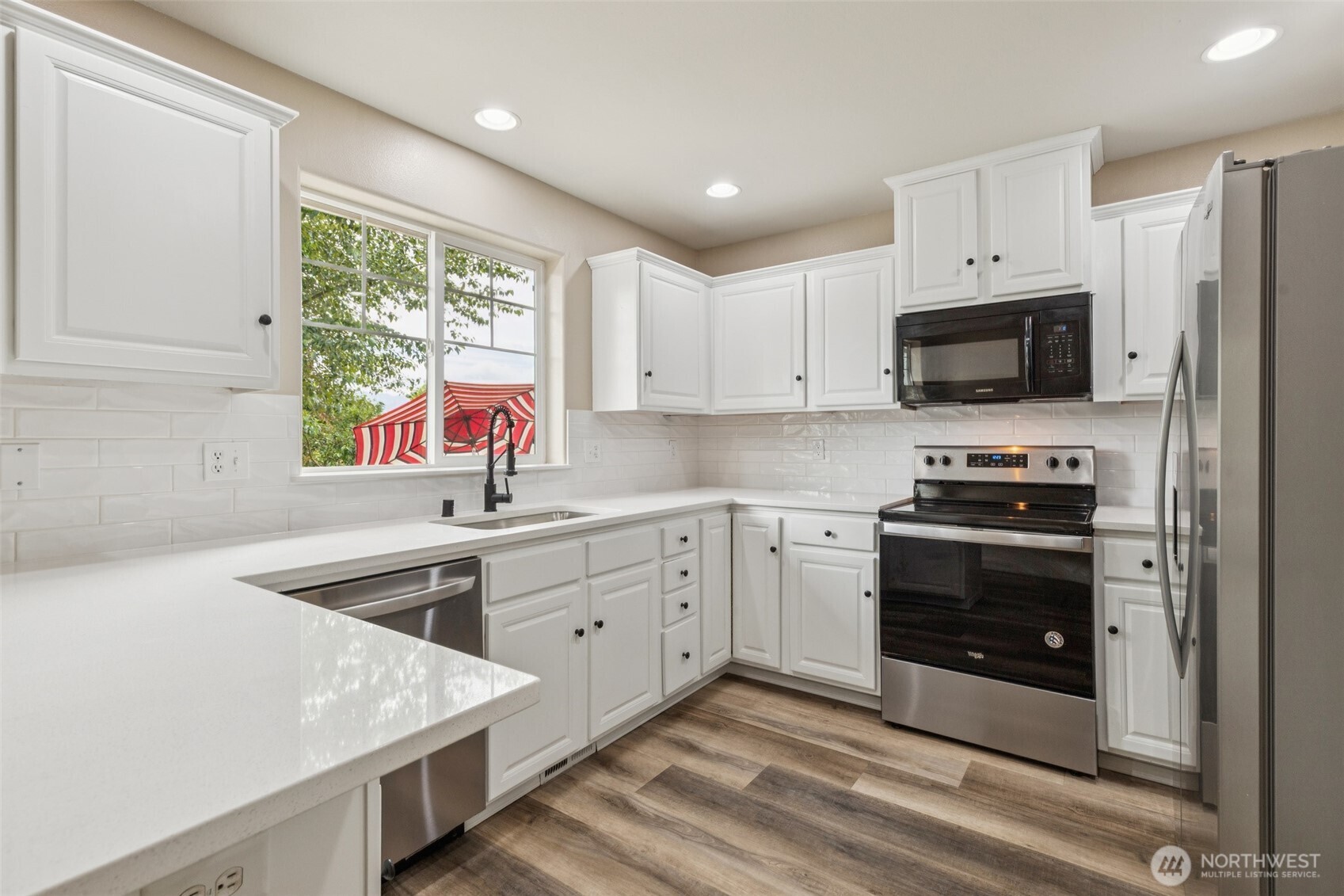 323 Helen Street Sedro-Woolley, WA 98284 - Photo 16 of 34 a kitchen with granite countertop a stove sink and microwave