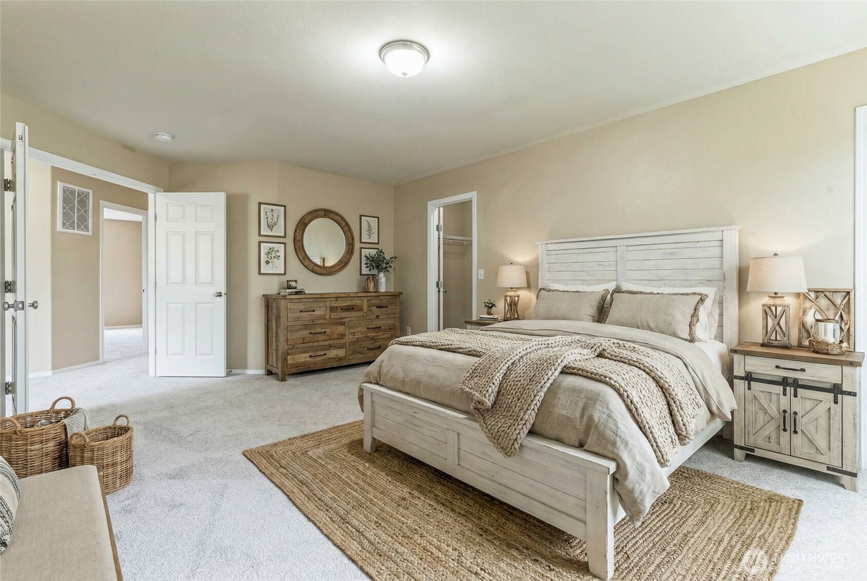 323 Helen Street Sedro-Woolley, WA 98284 - Photo 19 of 34 a spacious bedroom with a bed a mirror and lamp