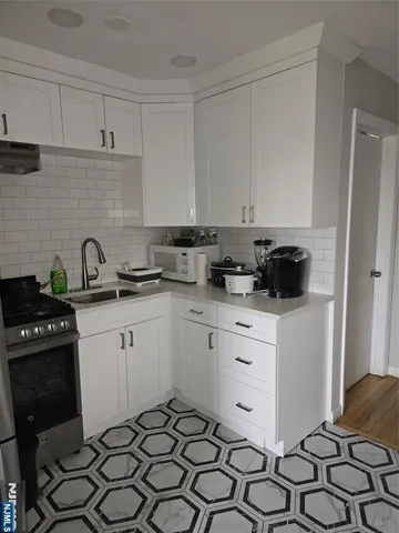 a kitchen with a sink and cabinets