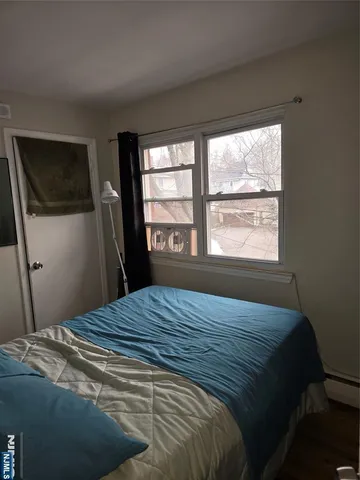 a bed sitting in a bedroom next to a window