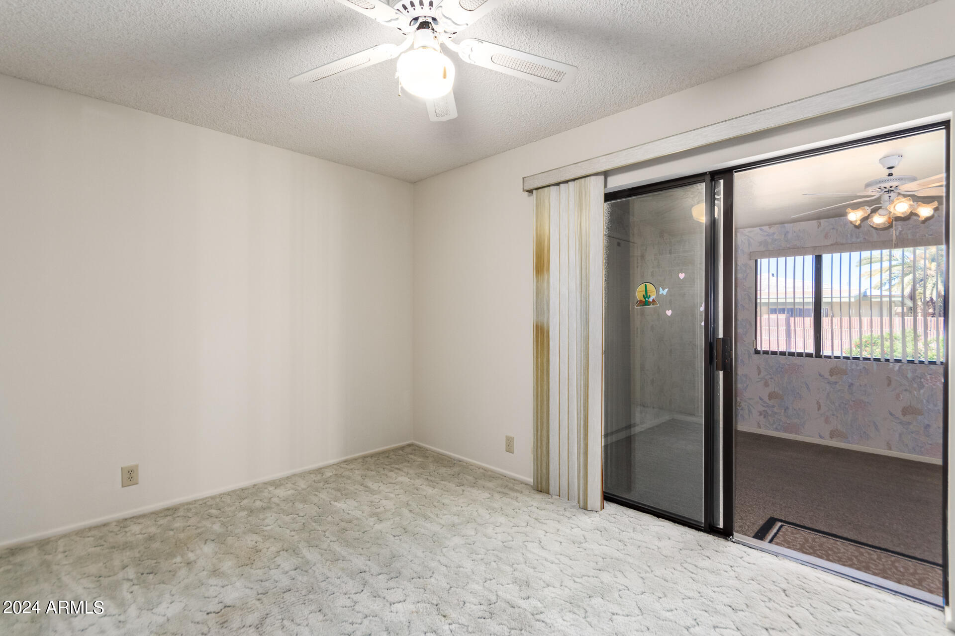 520 South Greenfield Road, Unit 39 Mesa, AZ 85206 - Photo 12 of 19 an empty room with chandelier fan