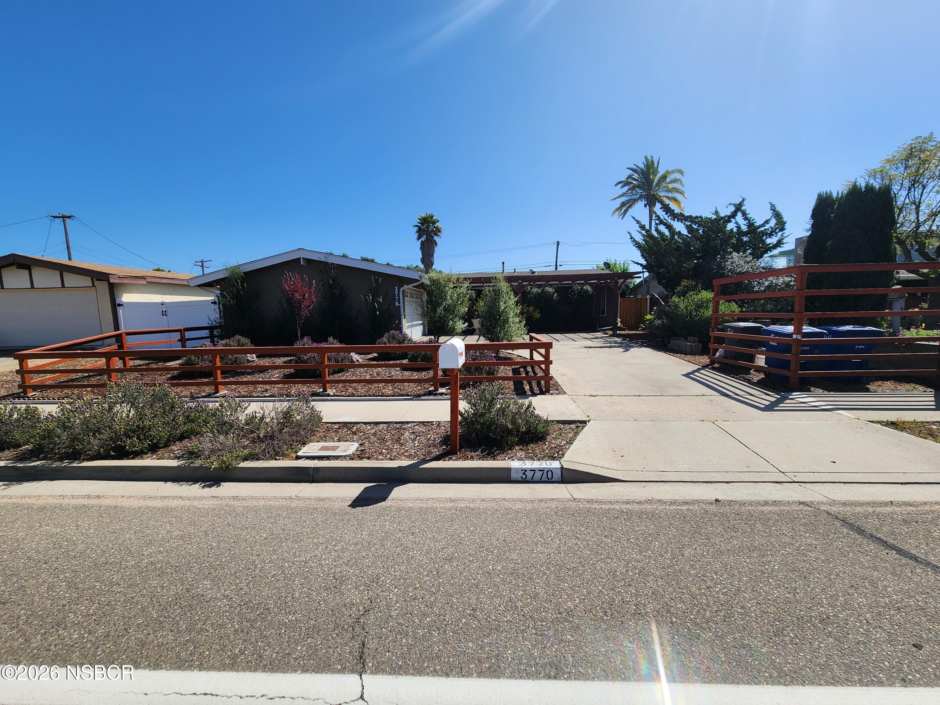 a view of a patio with a table and chairs under an umbrella