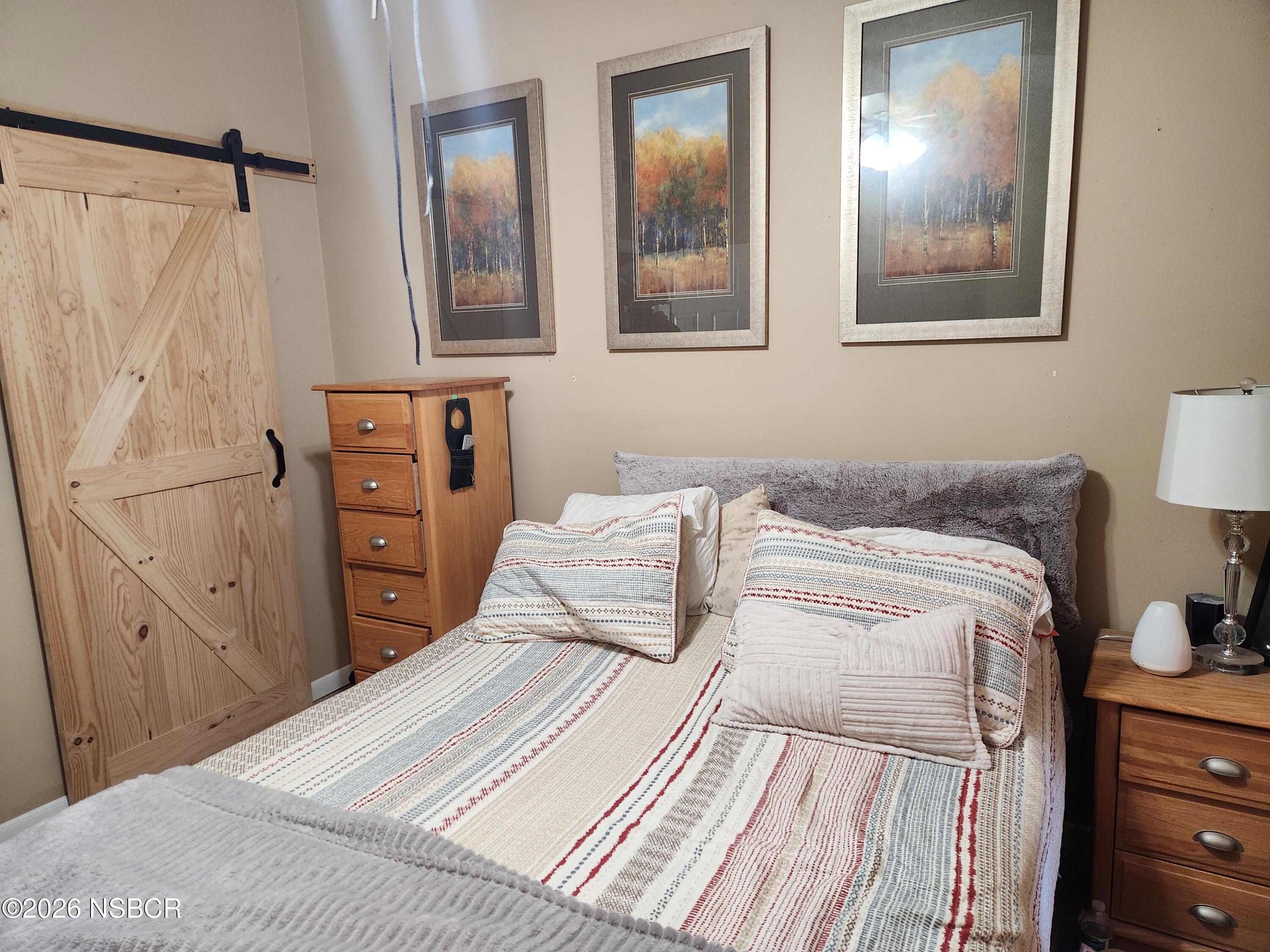 3770 Rucker Road Lompoc, CA 93436 - Photo 13 of 36 a bedroom with a bed and a lamp on dresser