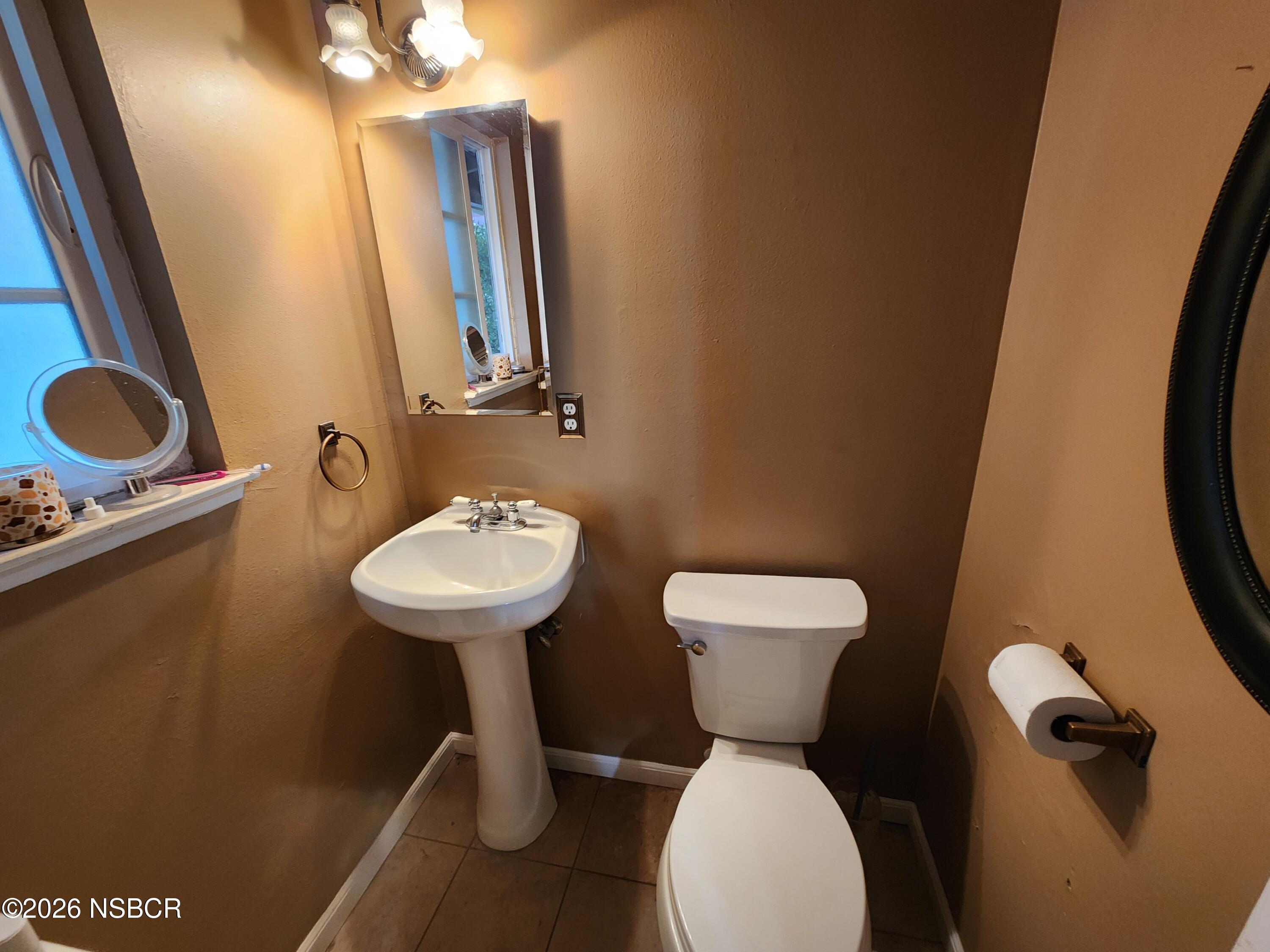 3770 Rucker Road Lompoc, CA 93436 - Photo 15 of 36 a bathroom with a toilet sink and mirror