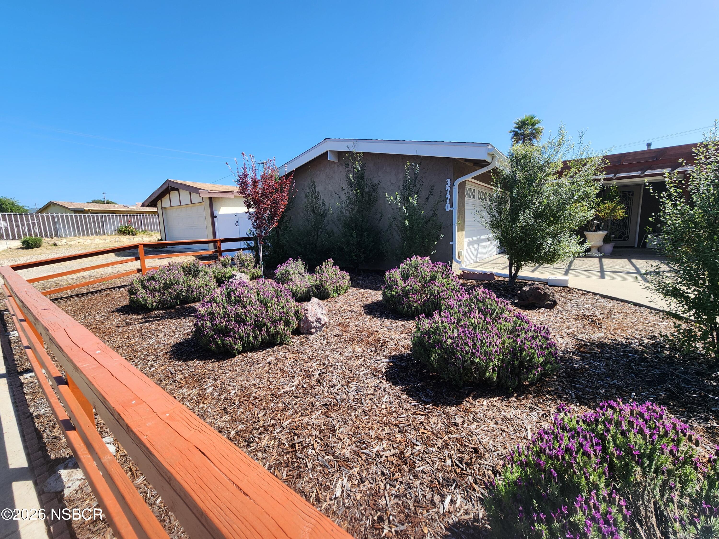 3770 Rucker Road Lompoc, CA 93436 - Photo 4 of 36 a wooden bench sitting in front of a building