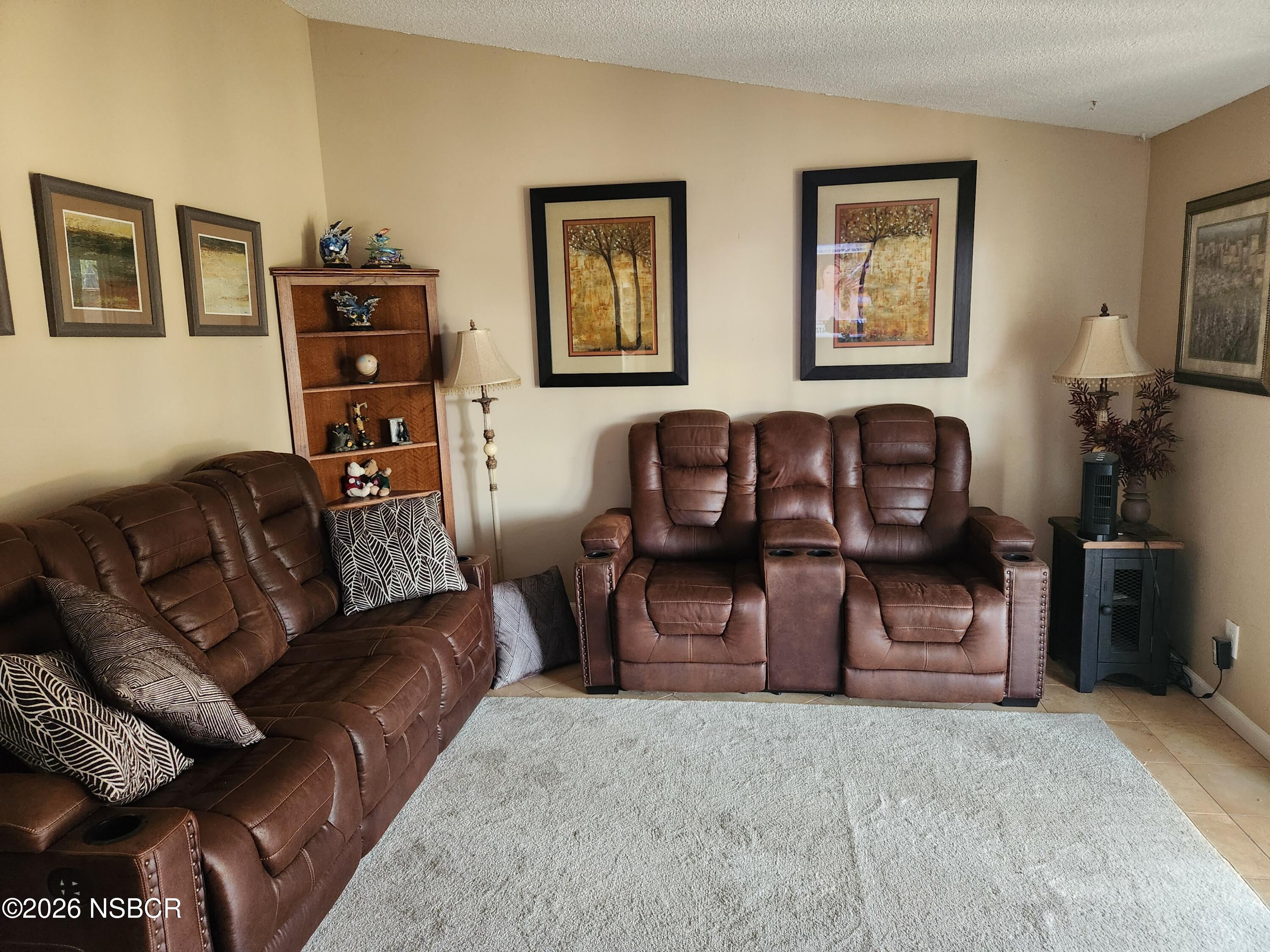 3770 Rucker Road Lompoc, CA 93436 - Photo 6 of 36 a living room with furniture a couch and paintings on the wall