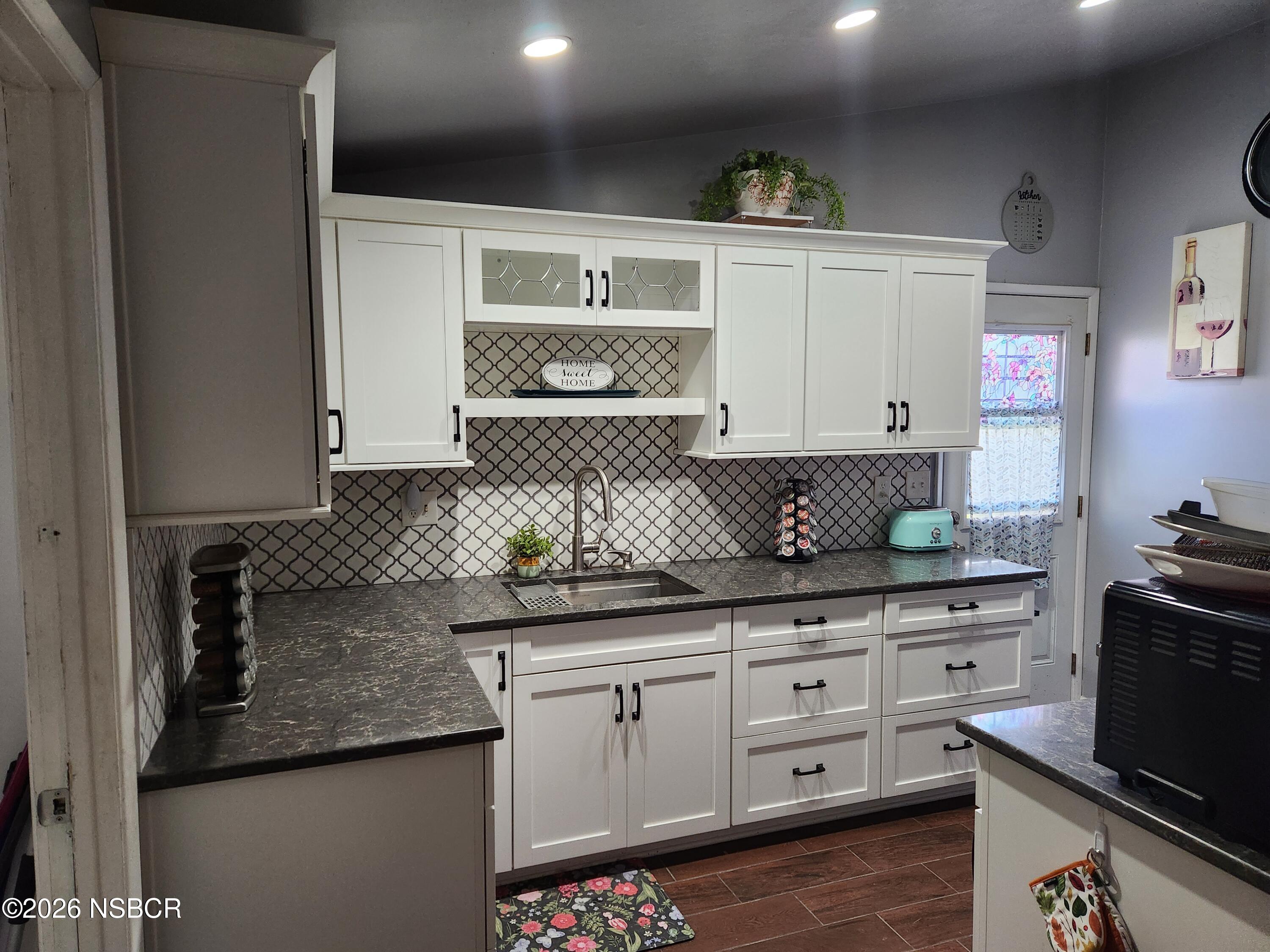 3770 Rucker Road Lompoc, CA 93436 - Photo 8 of 36 a kitchen with granite countertop a sink and cabinets