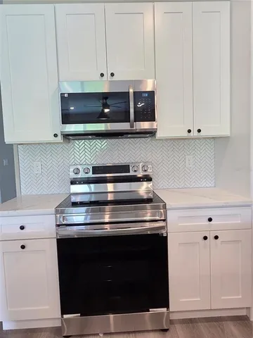 a stove top oven sitting inside of a kitchen
