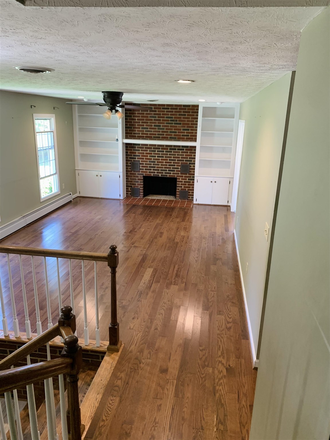 197 Kindig Road Waynesboro, VA 22980 - Photo 5 of 17 a view of a livingroom with wooden floor and a fireplace