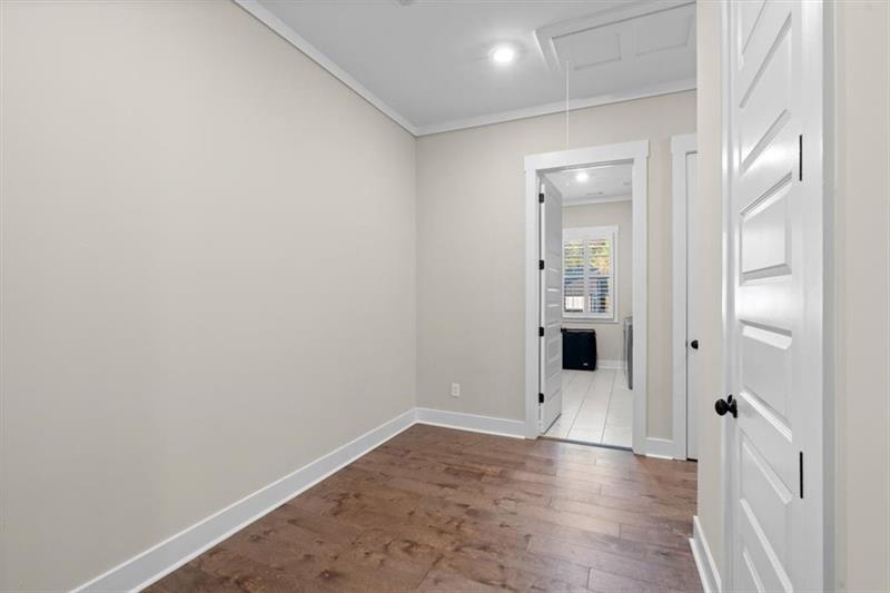 283 London Road Ball Ground, GA 30107 - Photo 36 of 73 an empty room with wooden floor and mirror