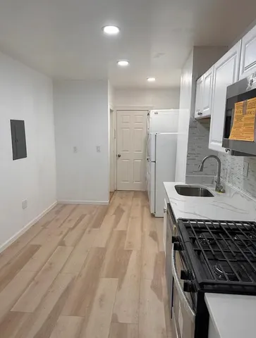 a kitchen with a stove and a sink