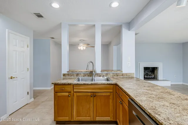 an empty room with windows and fireplace