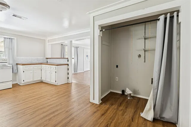 a view of a kitchen with wooden floor and a sink