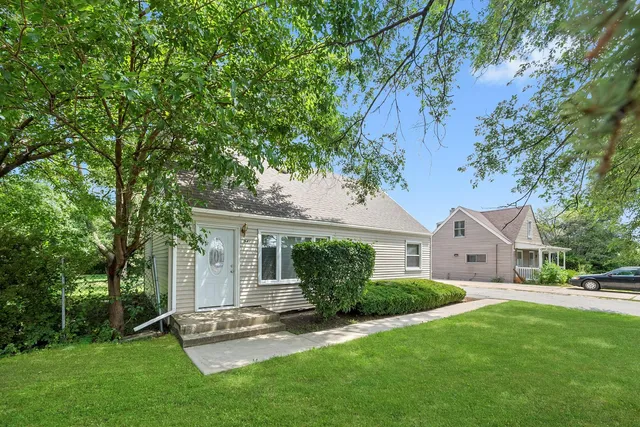 a aerial view of a house with a yard and large trees