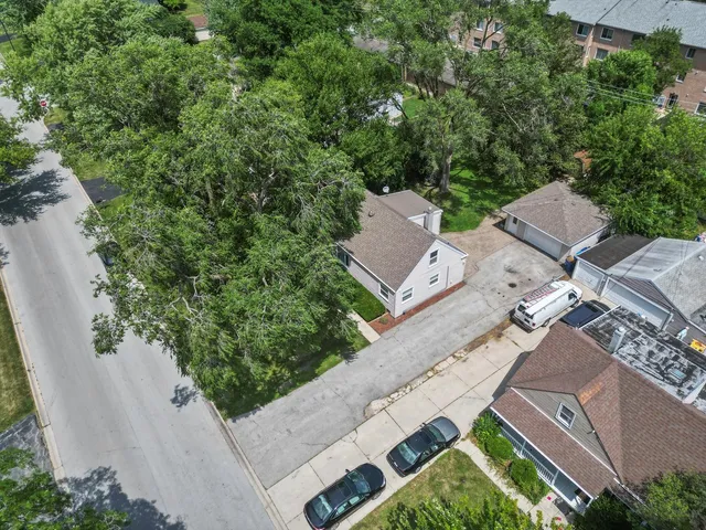 an aerial view of a house with a yard
