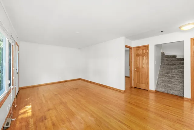 a kitchen with stainless steel appliances granite countertop a sink cabinets and wooden floor