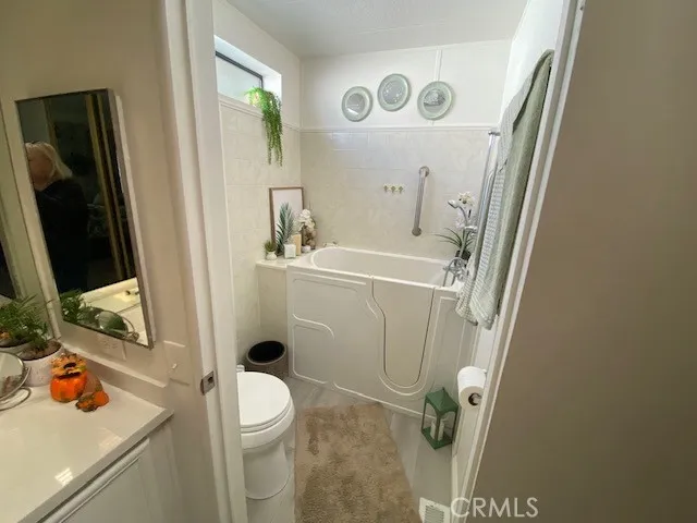 a bathroom with a sink a toilet and shower curtain