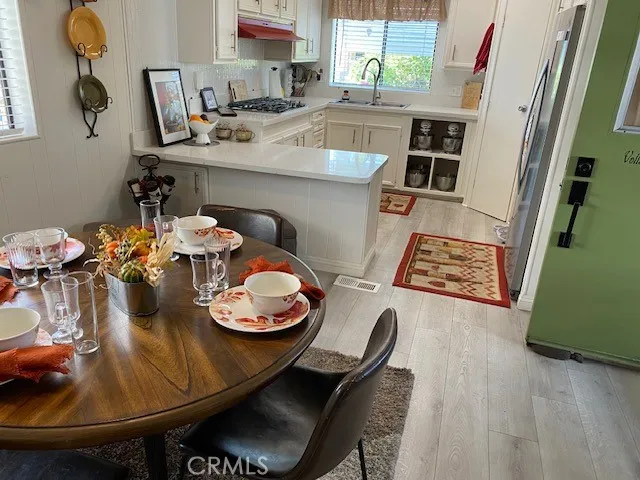 a dining room with furniture and wooden floor