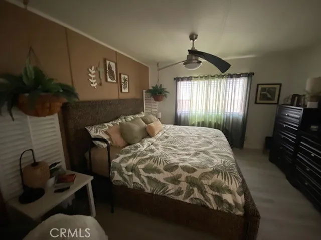 a spacious bedroom with a bed and a chandelier