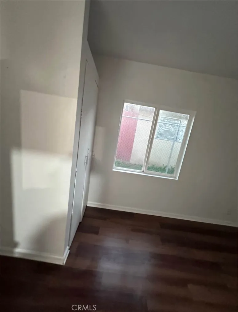 634 33rd Street Bakersfield, CA 93301 - Photo 22 of 39 an empty room with wooden floor and windows