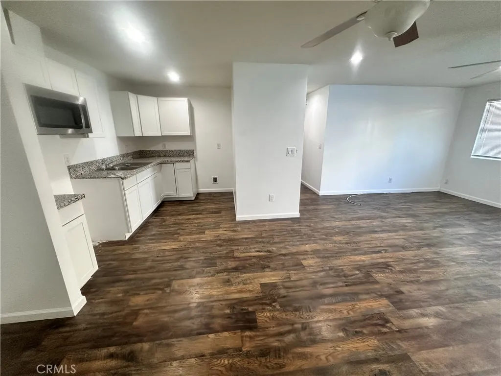 634 33rd Street Bakersfield, CA 93301 - Photo 33 of 39 a large kitchen with white cabinets and stainless steel appliances