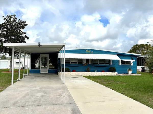 a view of a house with backyard porch and sitting area