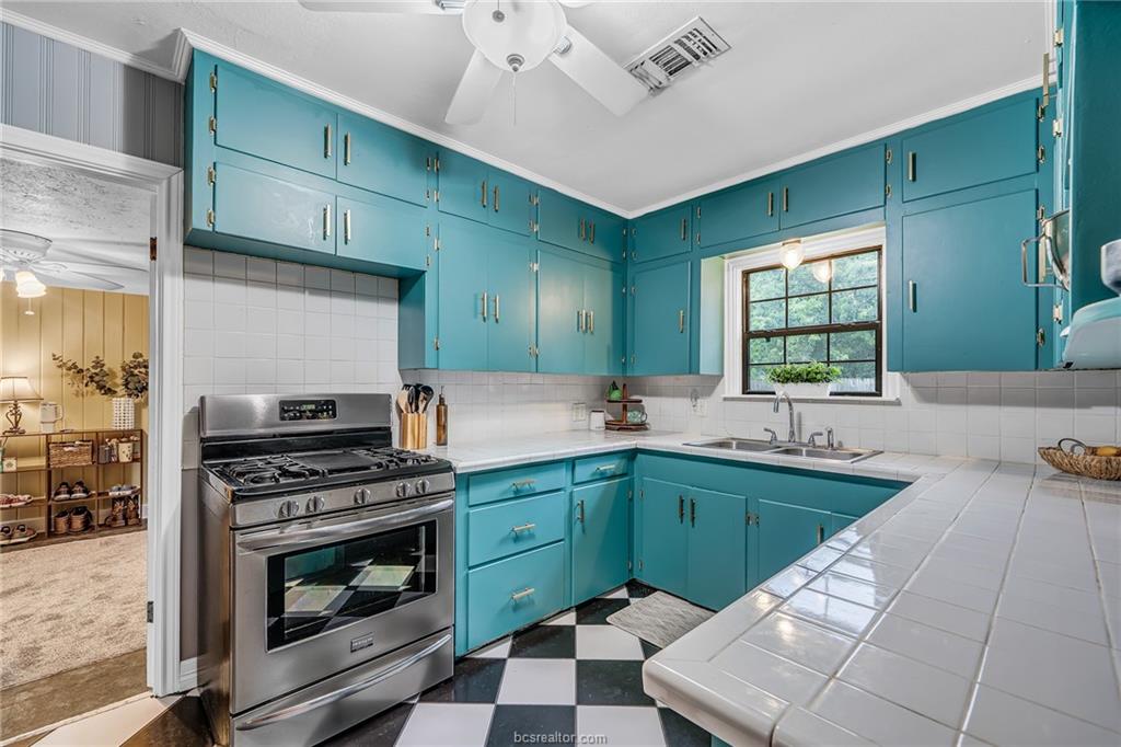 1414 East 29th Street Bryan, TX 77802 - Photo 10 of 21 a kitchen with lots of counter top space appliances and windows