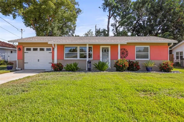 a kitchen with stainless steel appliances granite countertop a refrigerator stove and sink