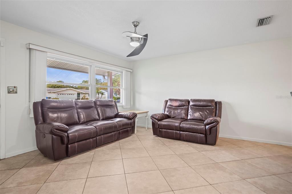 1215 Lazy Lake Road East Dunedin, FL 34698 - Photo 14 of 46 a living room with couches and furniture