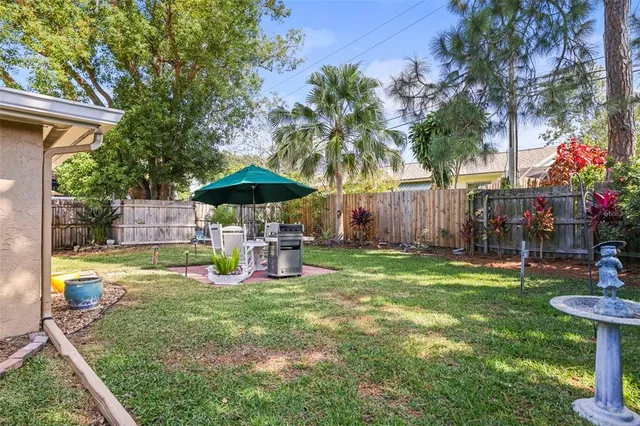 a view of an house with backyard and patio