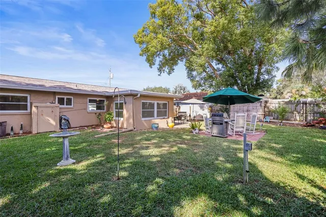 a view of a house with backyard porch and garden